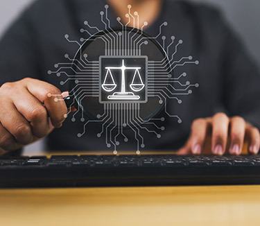 a person sitting behind a keyboard with scales of justice spelling out AI