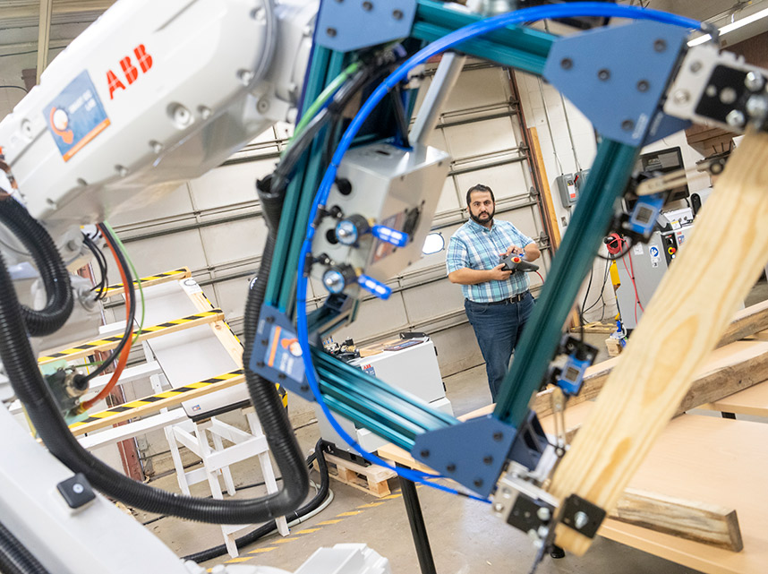 A UF faculty member using robotic aids in construction