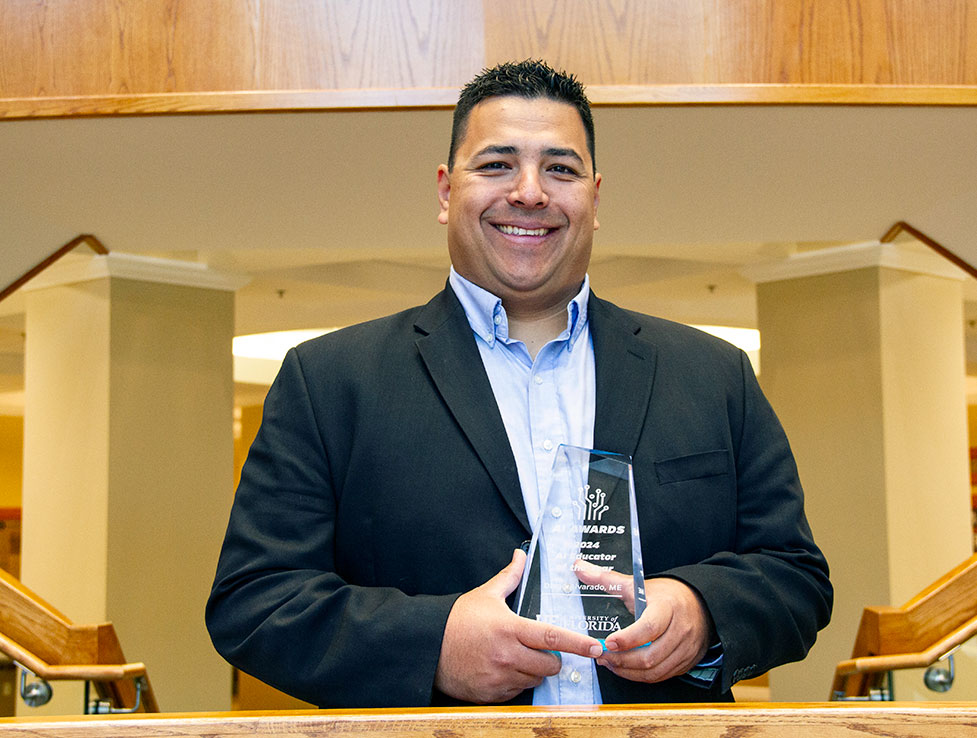 Diego Alvarado is pictured with his AI Educator of the Year Award