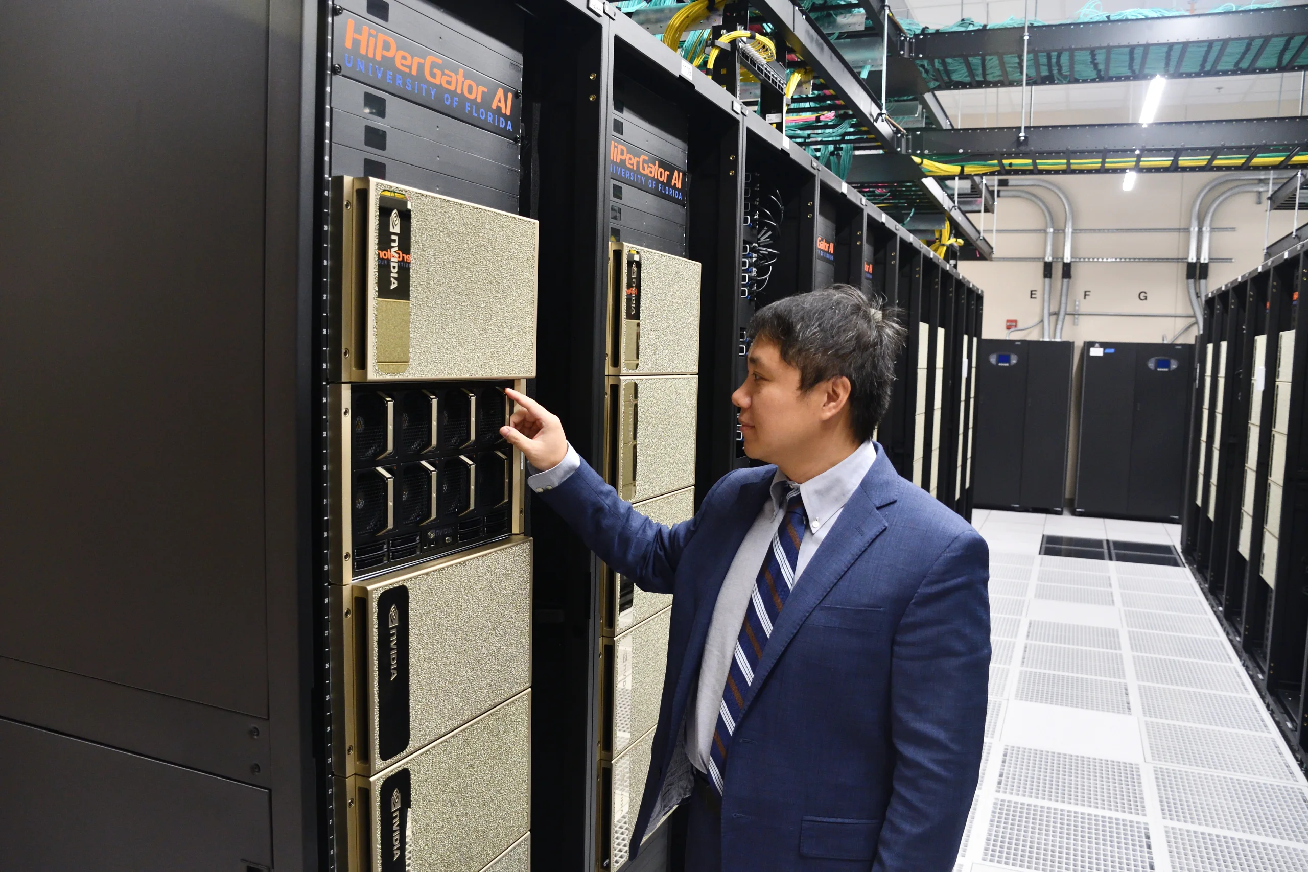 YongHui Wu next to HiperGator supercomputer