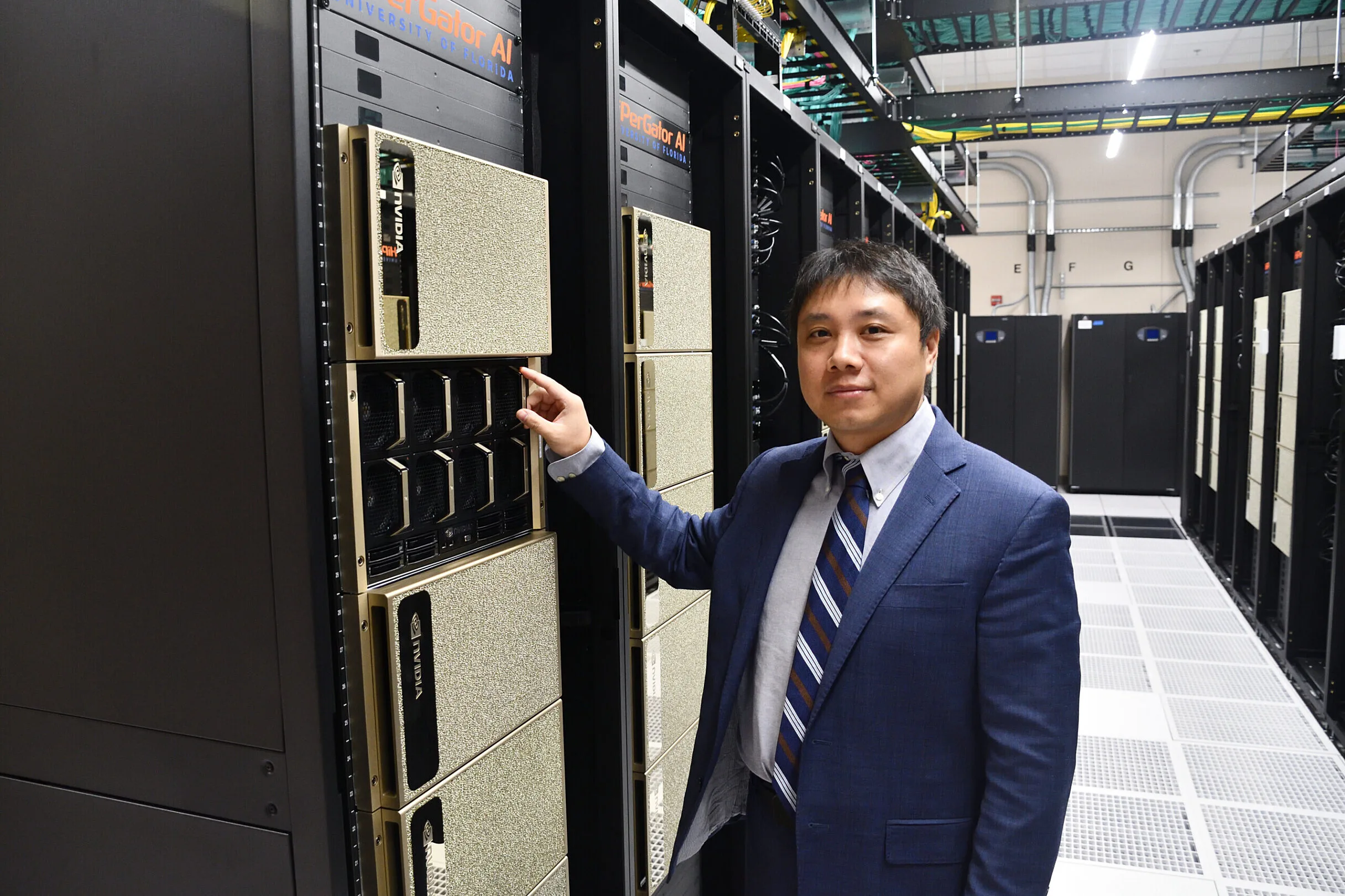 Yonghui Wu, Ph.D., stands beside the HiPerGator, the supercomputer at the University of Florida that supported his research in artificial intelligence