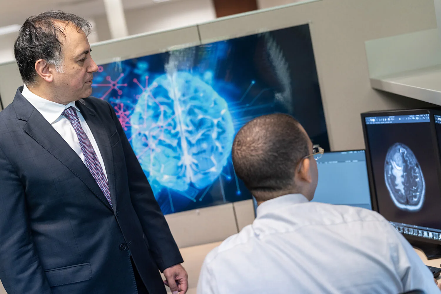 Two doctors looking at a radiology scan